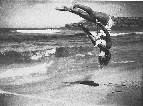 Peggy Bacon in mid-air backflip, Bondi Beach, Sydney, 6/2/1937 / by Ted Hood