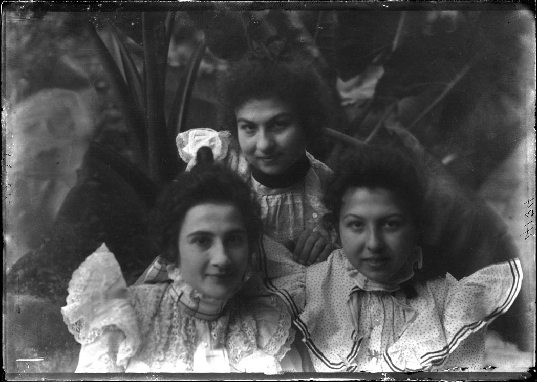 Three women in ruffled dresses